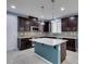 Updated kitchen with granite island, stainless steel appliances, and tiled backsplash at 1417 Brushback Ave, Henderson, NV 89074