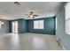 Spacious living room with tile flooring, ceiling fan, and sliding glass door to the backyard at 1417 Brushback Ave, Henderson, NV 89074