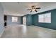 Open living area with tile floors, a ceiling fan, and sliding glass doors to the backyard at 1417 Brushback Ave, Henderson, NV 89074
