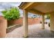 Outdoor covered patio featuring brick flooring and a large retaining wall with beautiful plants at 1417 Brushback Ave, Henderson, NV 89074