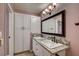 Full bathroom with double sinks, granite countertops, and white cabinets at 1575 W Warm Springs Rd # 413, Henderson, NV 89014