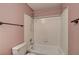 Full bathroom featuring a shower-tub combo and white tile surround at 1575 W Warm Springs Rd # 413, Henderson, NV 89014
