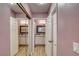 Hallway view of dual sink bathroom vanity and mirrored closet doors at 1575 W Warm Springs Rd # 413, Henderson, NV 89014