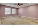 Bedroom with two windows, ceiling fan and laminate wood floors at 1575 W Warm Springs Rd # 413, Henderson, NV 89014