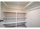 Walk-in closet with built-in shelving and laminate flooring at 1575 W Warm Springs Rd # 413, Henderson, NV 89014