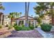 Exterior view of the clubhouse with well-maintained landscaping, a gray stone walkway and mature palm trees at 1575 W Warm Springs Rd # 413, Henderson, NV 89014