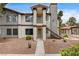 Condo exterior showing the light stucco facade, exterior staircase, and well-kept landscaping at 1575 W Warm Springs Rd # 413, Henderson, NV 89014
