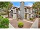 Inviting condo featuring a stucco facade, a decorative chimney, and an external staircase at 1575 W Warm Springs Rd # 413, Henderson, NV 89014