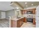 Kitchen with breakfast bar, dark wood cabinets, granite counters and stainless steel appliances at 1575 W Warm Springs Rd # 413, Henderson, NV 89014