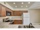 Kitchen with dark wood cabinets, granite counters, stainless steel appliances and breakfast bar at 1575 W Warm Springs Rd # 413, Henderson, NV 89014