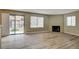 Cozy living room with wood flooring, fireplace, and a sliding glass door leading to a patio at 1575 W Warm Springs Rd # 413, Henderson, NV 89014