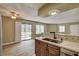 Open concept living area with kitchen view, wood floors and sliding glass door at 1575 W Warm Springs Rd # 413, Henderson, NV 89014