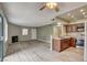 Open-concept living room with new flooring, a kitchen area, and natural light from windows at 1575 W Warm Springs Rd # 413, Henderson, NV 89014