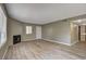 Inviting living area features laminate floors, a fireplace, and an adjoining kitchen area at 1575 W Warm Springs Rd # 413, Henderson, NV 89014