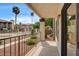 Balcony view showcases community pool with manicured landscaping and palm trees under a sunny sky at 1575 W Warm Springs Rd # 413, Henderson, NV 89014