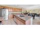 Open kitchen with granite countertops, stainless steel appliances, wood cabinets, and view to the dining and living areas at 1604 Danielle Rebecca Ave, North Las Vegas, NV 89086