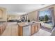 Open kitchen featuring granite counters, stainless appliances, view to the pool and access to living and dining area at 1604 Danielle Rebecca Ave, North Las Vegas, NV 89086