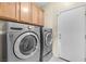 Laundry room with wood cabinets and new appliances at 1604 Danielle Rebecca Ave, North Las Vegas, NV 89086