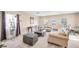 Bright living room featuring comfortable seating, neutral tones, and ample natural light at 1604 Danielle Rebecca Ave, North Las Vegas, NV 89086