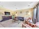 Cozy living room featuring a plush sofa, a TV, and soft lighting at 1604 Danielle Rebecca Ave, North Las Vegas, NV 89086