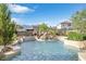 Backyard pool with waterfall feature and landscaped garden at 1604 Danielle Rebecca Ave, North Las Vegas, NV 89086