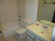Compact bathroom showing a bath tub, toilet, sink, and neutral tiled floor and shower at 1675 Jupiter Ct # C, Las Vegas, NV 89119