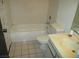Bathroom featuring a standard tub, toilet, and vanity with neutral tile flooring at 1675 Jupiter Ct # C, Las Vegas, NV 89119