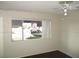 Cozy room with a window view of the street, carpet flooring and a ceiling fan at 1675 Jupiter Ct # C, Las Vegas, NV 89119
