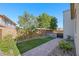 Landscaped backyard features manicured lawn, mature trees, and attractive hardscaping at 234 Polaris Ridge Ave, Henderson, NV 89011