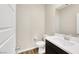 Modern powder room with white vanity, dark cabinets, and stylish fixtures at 234 Polaris Ridge Ave, Henderson, NV 89011