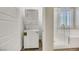 Bathroom featuring a stacked washer/dryer with shower and soaking tub at 234 Polaris Ridge Ave, Henderson, NV 89011