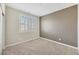 Cozy bedroom featuring neutral carpet, a shuttered window and a two-tone paint scheme, ideal for relaxation at 234 Polaris Ridge Ave, Henderson, NV 89011