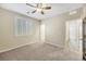 Comfortable bedroom with plush carpet, a ceiling fan, and a shuttered window, creating a relaxing space at 234 Polaris Ridge Ave, Henderson, NV 89011