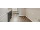 Functional laundry room with wood-look floors, black cabinets and ample shelf storage, ideal for organization and convenience at 234 Polaris Ridge Ave, Henderson, NV 89011