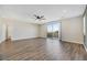 Open-concept living area with wood floors, recessed lighting, neutral paint and a sliding glass door to a balcony at 234 Polaris Ridge Ave, Henderson, NV 89011