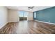 Expansive living area with lots of natural light, ceiling fan and wood flooring, ideal for relaxation and entertaining at 234 Polaris Ridge Ave, Henderson, NV 89011