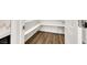 Walk-in pantry offering ample storage with white shelving and wood-look flooring at 234 Polaris Ridge Ave, Henderson, NV 89011