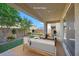 Comfortable covered patio area features outdoor seating and views of the landscaped backyard at 234 Polaris Ridge Ave, Henderson, NV 89011