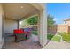 Covered patio area features outdoor seating and views of the landscaped backyard with pavers at 234 Polaris Ridge Ave, Henderson, NV 89011