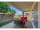 Covered patio area features outdoor seating and views of the landscaped backyard at 234 Polaris Ridge Ave, Henderson, NV 89011