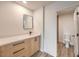 Modern bathroom with single vanity, wood cabinets, and toilet in separate room at 2606 S Durango Dr # 117, Las Vegas, NV 89117