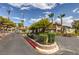 Gated community entrance featuring lush landscaping, mature palm trees, and well-maintained surroundings at 2606 S Durango Dr # 117, Las Vegas, NV 89117
