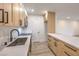 Contemporary kitchen with stainless steel appliances, light wood cabinetry and stone countertops at 2606 S Durango Dr # 117, Las Vegas, NV 89117
