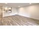 Open living area with wood flooring and a kitchen in the background at 2606 S Durango Dr # 117, Las Vegas, NV 89117