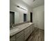 Bathroom featuring a double sink vanity with granite countertops and neutral-toned flooring at 2637 Red Rock St # 202, Las Vegas, NV 89146