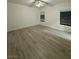 Spacious bedroom with wood-look flooring, two windows and a ceiling fan at 2637 Red Rock St # 202, Las Vegas, NV 89146