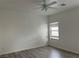 Bedroom with neutral walls, ceiling fan, window, and wood-look flooring at 2637 Red Rock St # 202, Las Vegas, NV 89146