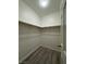 Walk-in closet with light wood-look flooring and a wooden rod for hanging clothes at 2637 Red Rock St # 202, Las Vegas, NV 89146