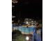 Nighttime view of a community pool surrounded by trees and modern architecture at 2637 Red Rock St # 202, Las Vegas, NV 89146