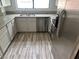 Bright kitchen with stainless steel appliances, stone countertops, and wood-look flooring at 2637 Red Rock St # 202, Las Vegas, NV 89146